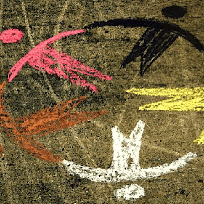 Colorful chalk figures forming a circle.