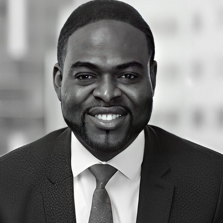 Smiling man in a suit and tie.